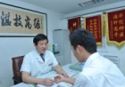 老中医郭老正在为前来就诊的患者把脉